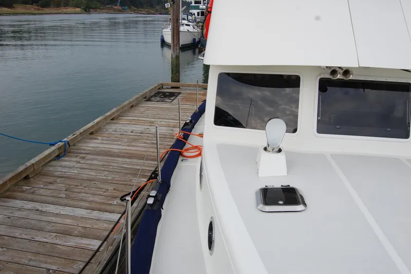 Slide: The Image of 1981 Willard Marine Pilot House Trawler docked at a wooden pier. - 63