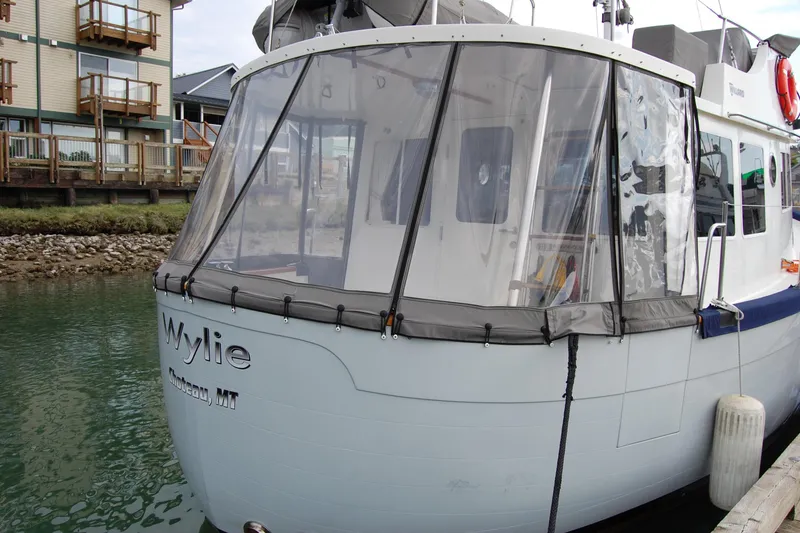 Slide: The Image of 1981 Willard Marine Pilot House Trawler docked near waterfront buildings. - 9