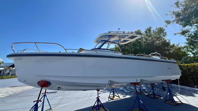 The Image of 2024 Nimbus Tender 8 #314 boat on stands under clear blue sky. - 1
