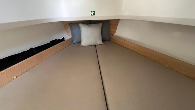 Slide: The Image of 2024 Nimbus Tender 8 #314 cabin interior with cozy bedding and cushions. - 11