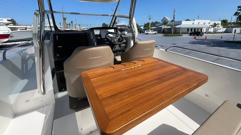 Slide: The Image of 2024 Nimbus Tender 8 #314 boat interior with wooden table and steering console. - 25