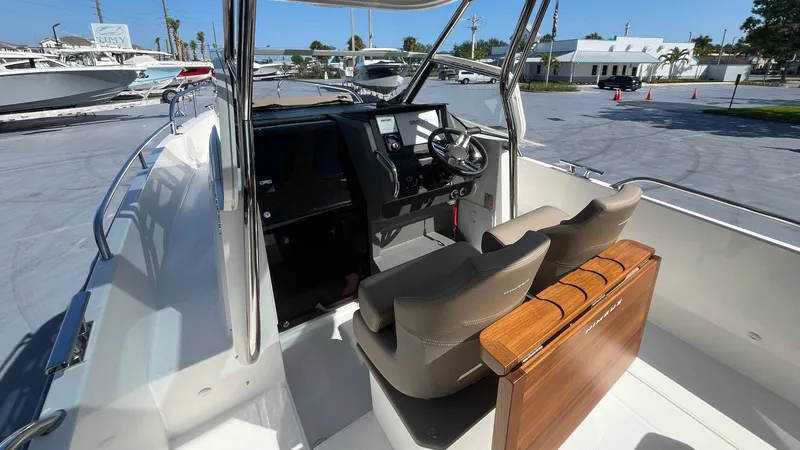 Slide: The Image of 2024 Nimbus Tender 8 #314 boat interior with dual seats and steering console. - 26