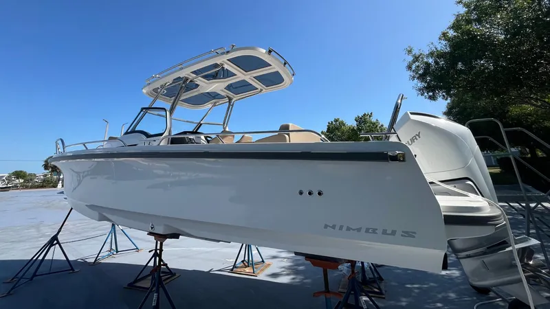 Slide: The Image of 2024 Nimbus Tender 8 #314 boat on stands, clear sky background. - 28