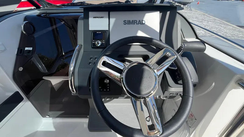 Slide: The Image of 2024 Nimbus Tender 8 #314 steering wheel and dashboard with Simrad navigation system. - 9