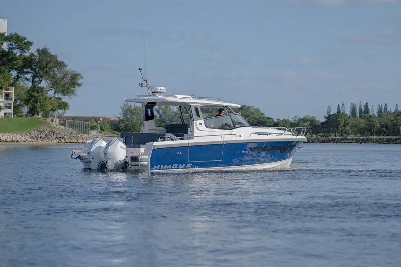 Slide: The Image of 2024 Nimbus Weekender 11 #20 boat cruising on a calm lake. - 1