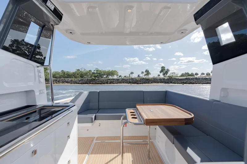 Slide: The Image of 2024 Nimbus Weekender 11 #20 boat interior with seating and dining area. - 16