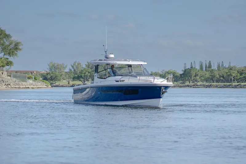 Slide: The Image of 2024 Nimbus Weekender 11 #20 boat cruising on a calm lake. - 2
