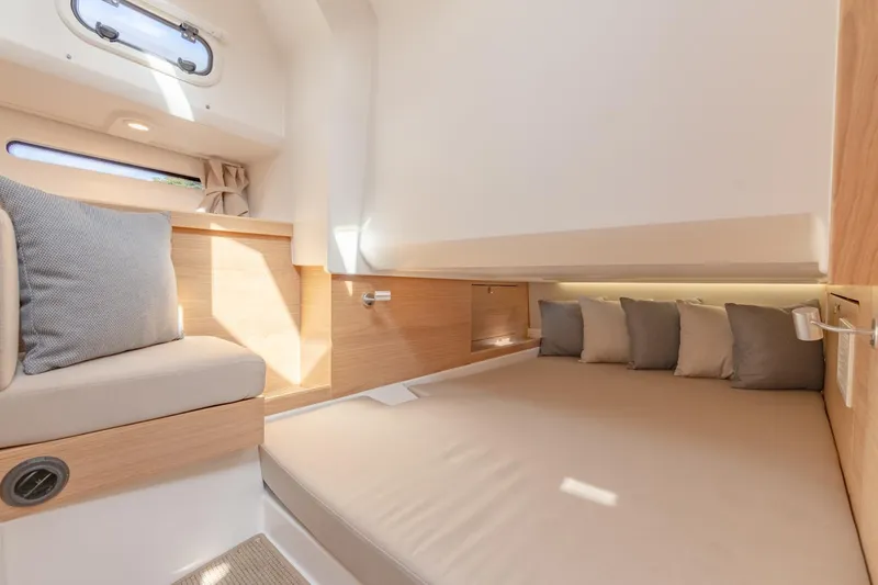 Slide: The Image of Modern interior cabin of 2024 Nimbus Weekender 11 #20 with cozy bedding and natural light. - 23