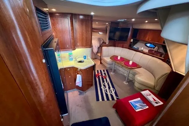 Slide: The Image of Luxurious interior of 2003 Cruisers Yachts 3772 Express with wood cabinetry and cozy seating. - 16