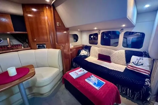 Slide: The Image of Interior of 2003 Cruisers Yachts 3772 Express with cozy seating and nautical decor. - 18