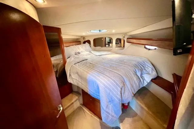 Slide: The Image of Luxurious cabin interior of 2003 Cruisers Yachts 3772 Express with cozy bed and wooden accents. - 23