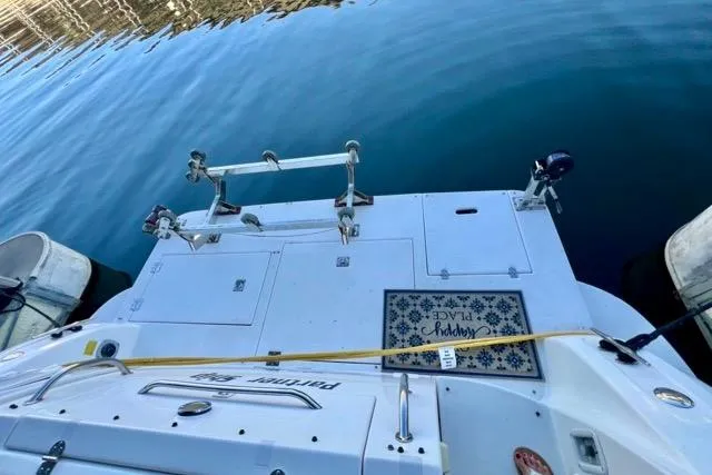 Slide: The Image of 2003 Cruisers Yachts 3772 Express docked, showing rear deck and water reflection. - 34