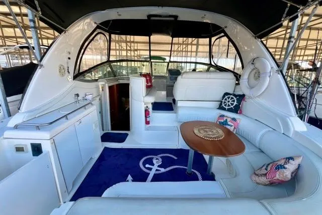 Slide: The Image of 2003 Cruisers Yachts 3772 Express interior with seating, table, and nautical decor. - 7