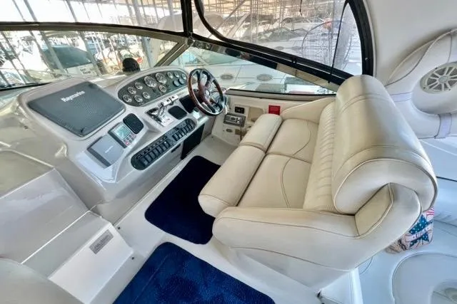 Slide: The Image of 2003 Cruisers Yachts 3772 Express helm with leather seating and modern controls. - 12