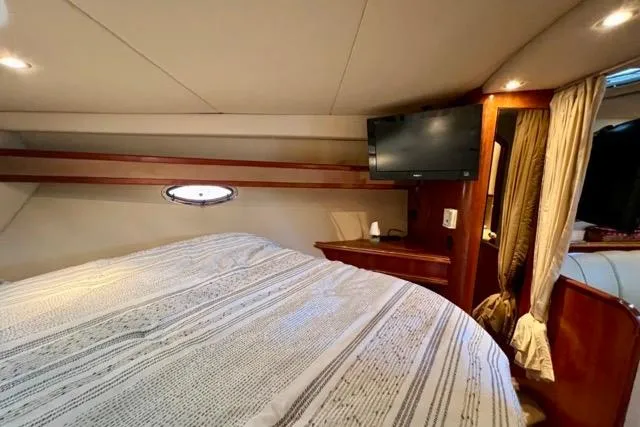 Slide: The Image of Interior cabin of 2003 Cruisers Yachts 3772 Express with bed and TV. - 24