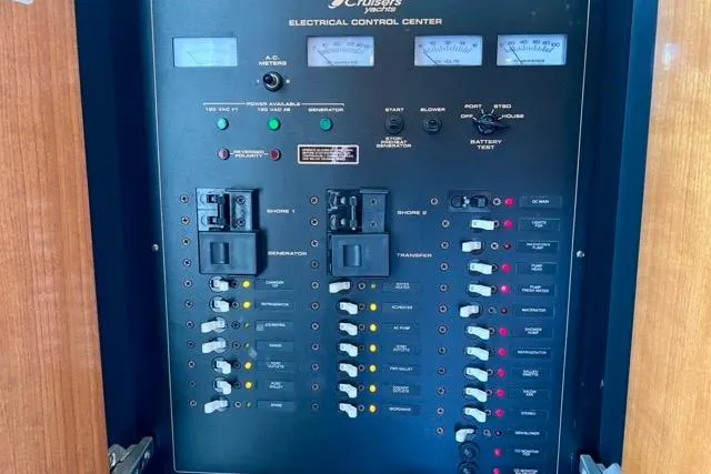 Slide: The Image of Electrical control panel of 2003 Cruisers Yachts 3772 Express, featuring switches and meters. - 25