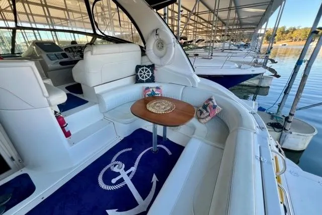 Slide: The Image of 2003 Cruisers Yachts 3772 Express interior with seating, table, and nautical decor. - 8