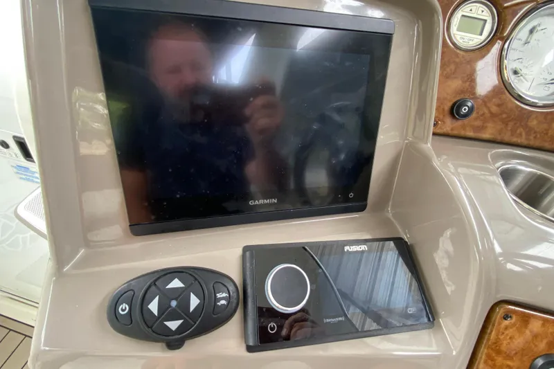 Slide: The Image of Dashboard of a 2008 Rinker 350 Express Cruiser with Garmin and Fusion displays. - 12