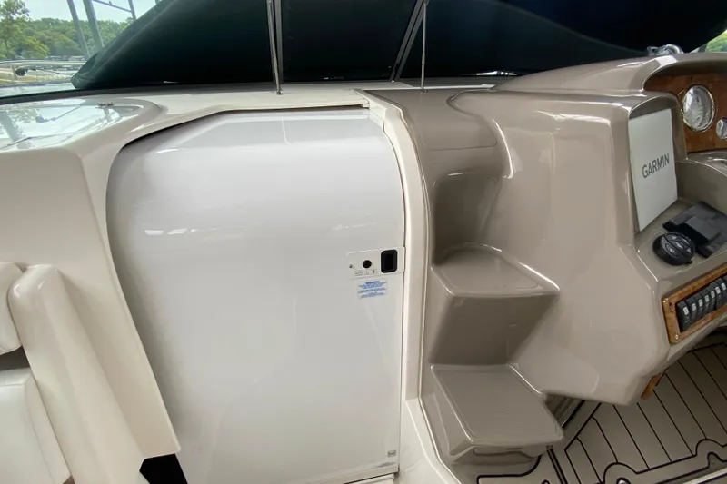 Slide: The Image of 2008 Rinker 350 Express Cruiser helm with Garmin navigation system and sleek interior design. - 13