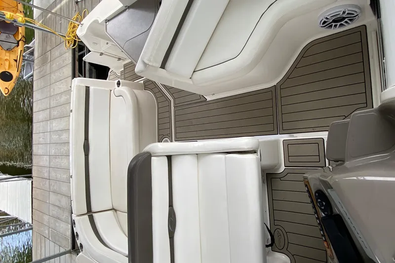 Slide: The Image of 2008 Rinker 350 Express Cruiser interior with white seating and teak-style flooring. - 14