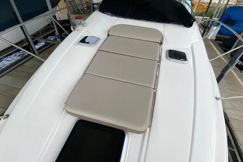Slide: The Image of 2008 Rinker 350 Express Cruiser with cushioned deck area, docked at marina. - 17
