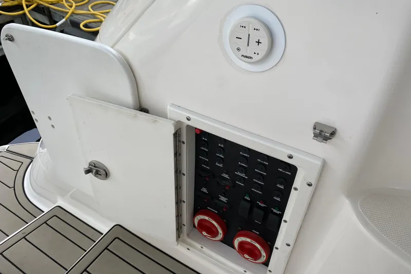 Slide: The Image of Control panel on a 2008 Rinker 350 Express Cruiser boat, featuring switches and dials. - 21