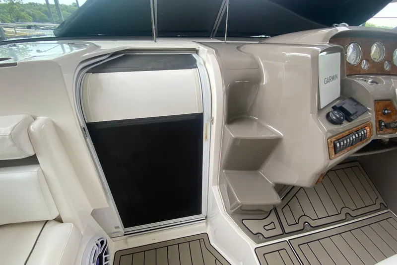 Slide: The Image of 2008 Rinker 350 Express Cruiser helm with Garmin navigation and cabin entry. - 24