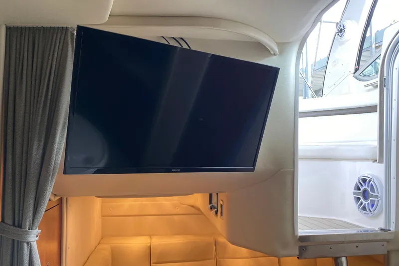 Slide: The Image of Interior of 2008 Rinker 350 Express Cruiser with mounted TV and cozy seating area. - 36