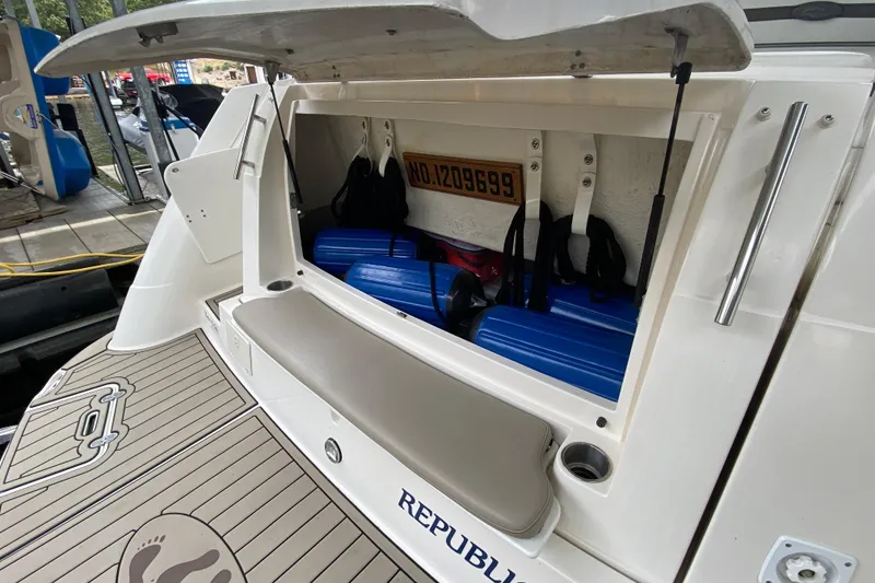Slide: The Image of 2008 Rinker 350 Express Cruiser storage compartment with blue fenders and accessories. - 4