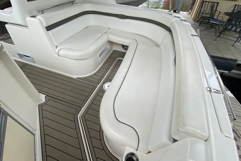 Slide: The Image of 2008 Rinker 350 Express Cruiser interior with white seating and teak-style flooring. - 5