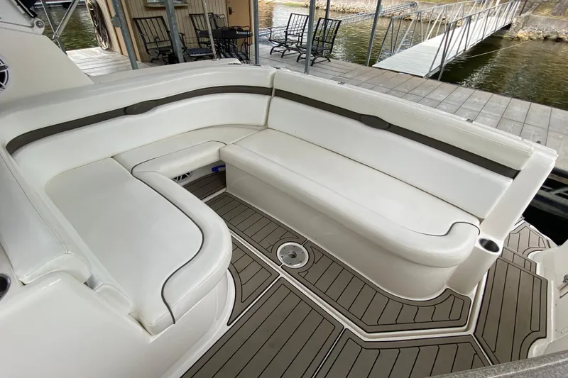 Slide: The Image of 2008 Rinker 350 Express Cruiser interior with white seating and teak-style flooring. - 6
