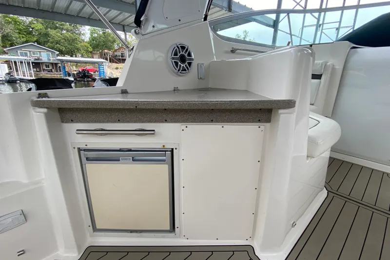 Slide: The Image of 2008 Rinker 350 Express Cruiser interior with kitchenette and seating area. - 7