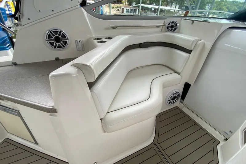 Slide: The Image of 2008 Rinker 350 Express Cruiser interior with white seating and marine speakers. - 9