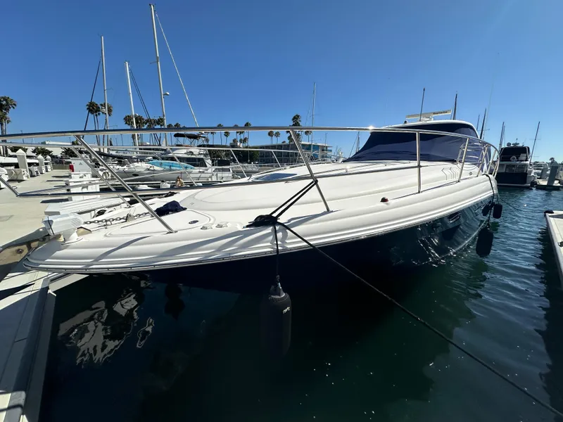 Slide: The Image of 2005 Sea Ray 420 Sundancer yacht docked in marina under clear blue sky. - 2