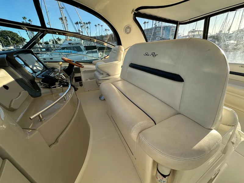 Slide: The Image of 2005 Sea Ray 420 Sundancer yacht interior with plush seating and helm. - 20