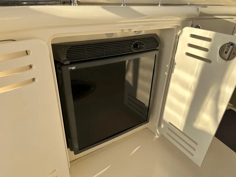 Slide: The Image of 2005 Sea Ray 420 Sundancer mini fridge with open cabinet door. - 28
