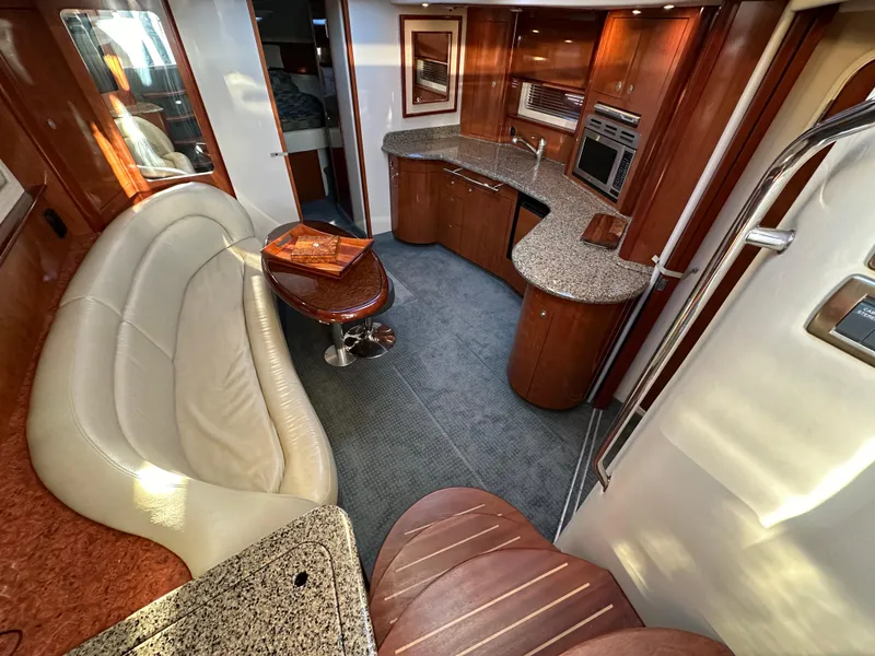 Slide: The Image of Luxurious 2005 Sea Ray 420 Sundancer yacht interior with elegant seating and modern kitchen. - 31