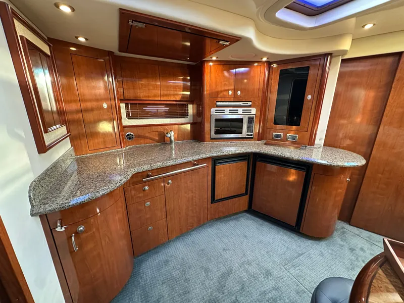 Slide: The Image of Luxurious 2005 Sea Ray 420 Sundancer yacht interior with modern kitchen amenities. - 33
