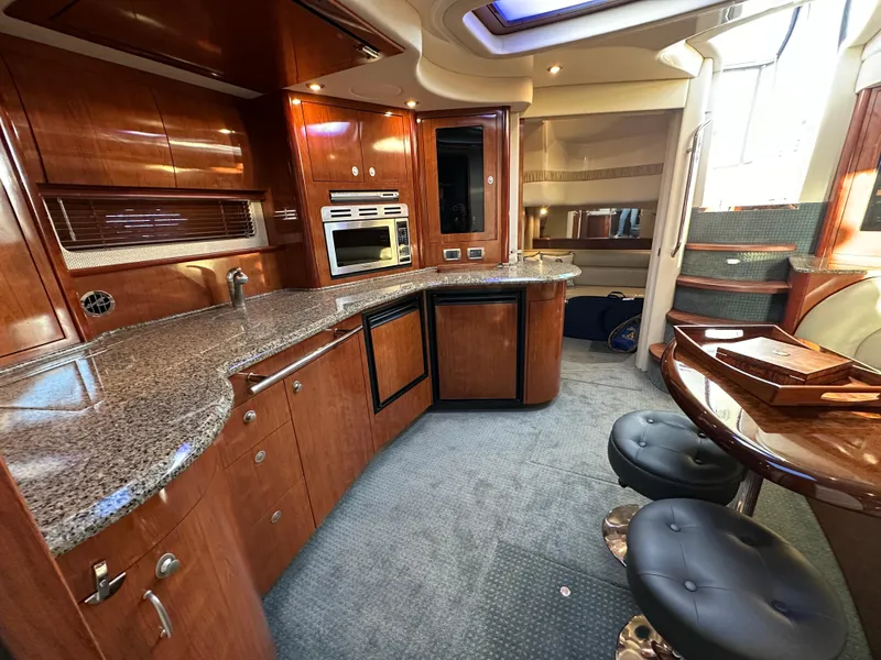 Slide: The Image of Luxurious 2005 Sea Ray 420 Sundancer yacht interior with modern kitchen and seating area. - 36