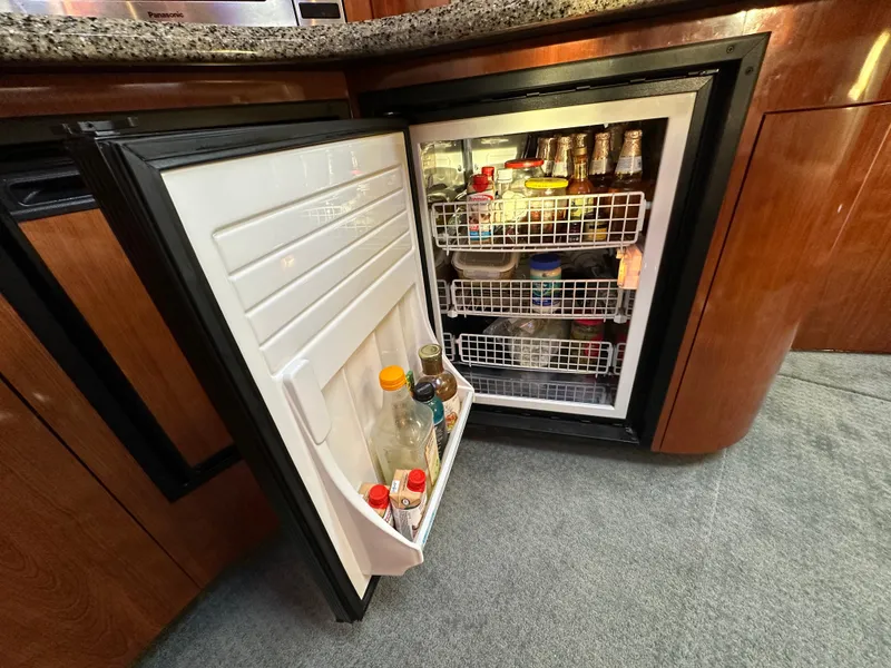 Slide: The Image of Open fridge in 2005 Sea Ray 420 Sundancer yacht kitchen, stocked with beverages and condiments. - 40