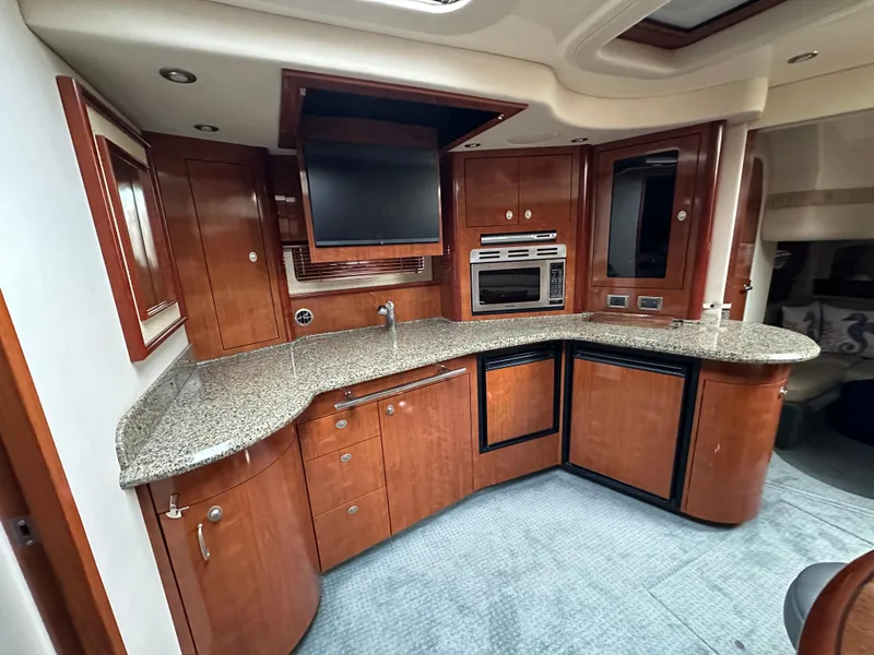 Slide: The Image of Luxurious 2005 Sea Ray 420 Sundancer yacht kitchen with modern appliances and elegant wood cabinetry. - 42