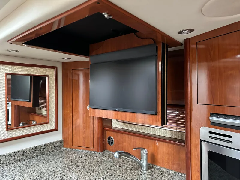 Slide: The Image of Luxurious interior of 2005 Sea Ray 420 Sundancer with TV and wood cabinetry. - 43