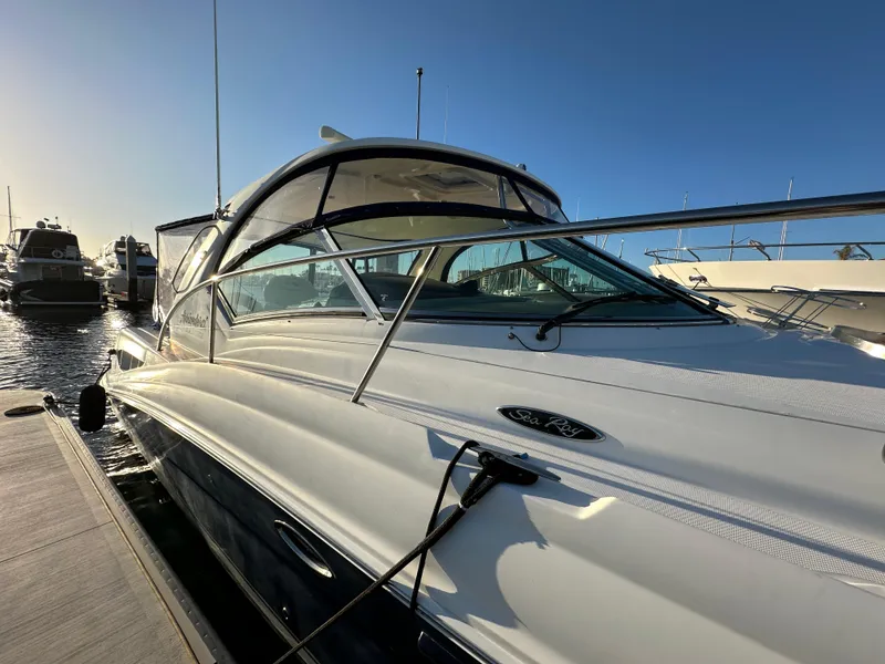 Slide: The Image of 2005 Sea Ray 420 Sundancer yacht docked at marina under clear blue sky. - 5