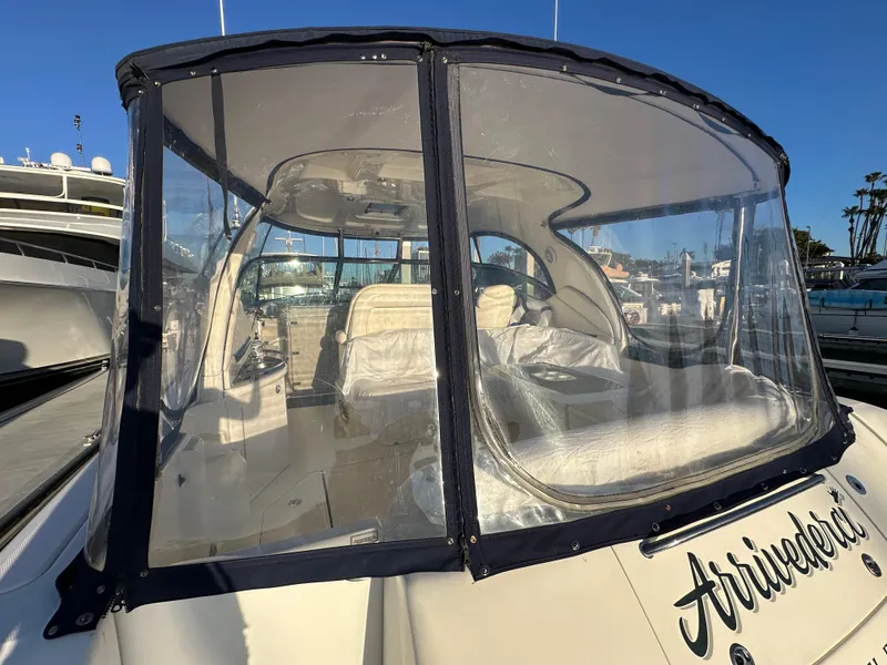 Slide: The Image of 2005 Sea Ray 420 Sundancer with clear cockpit enclosure in marina setting. - 8