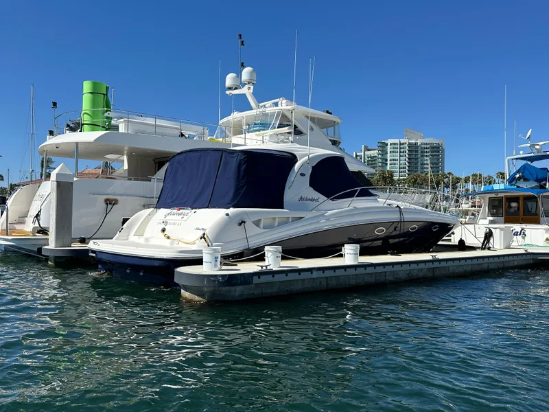 Slide: The Image of 2005 Sea Ray 420 Sundancer yacht docked in marina under clear blue sky. - 9