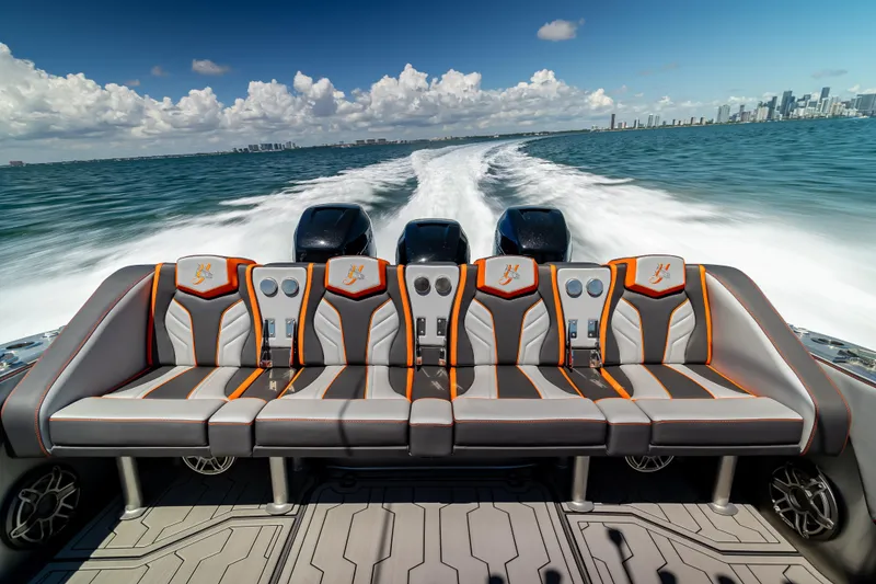 Slide: The Image of 2012 Yellowfin 39 boat with stylish seating, cruising on open water under a clear sky. - 14