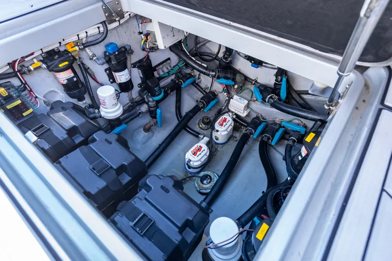 Slide: The Image of 2012 Yellowfin 39 boat engine compartment with batteries, filters, and wiring. - 15