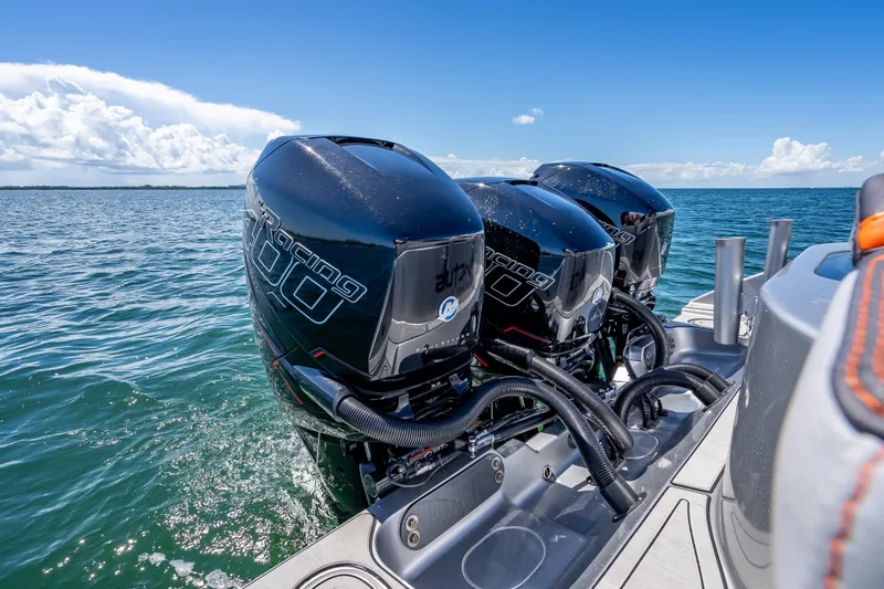 Slide: The Image of 2012 Yellowfin 39 boat with triple outboard engines on open water. - 18