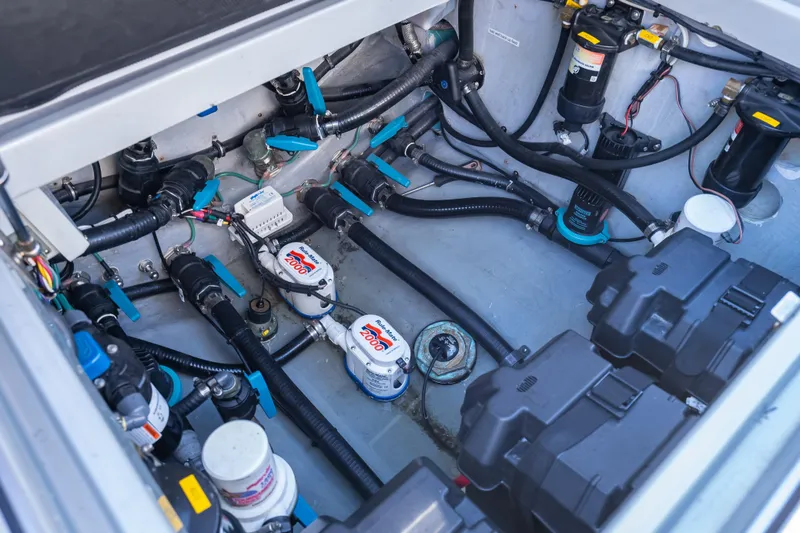 Slide: The Image of Engine compartment of a 2012 Yellowfin 39 boat, showcasing pumps and wiring. - 21
