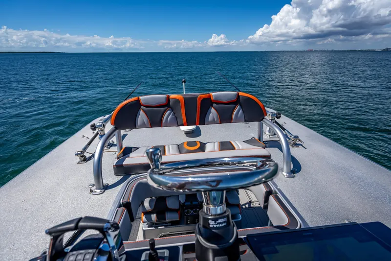 Slide: The Image of 2012 Yellowfin 39 boat on open water, featuring sleek seating and steering wheel. - 23